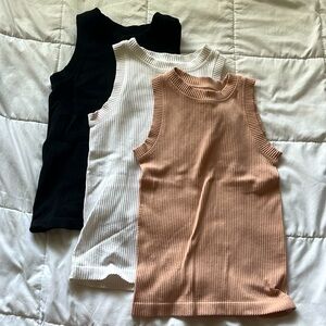 Black, white, and pink sleeveless tops.
